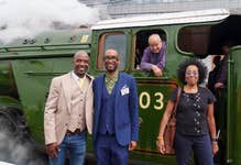 Molly Jackson (right) whose father Wilston Samuel Jackson became Britain’s first black train driver in 1962, and her nephews Wilston (left) and Eddie (second left) with the Flying Scotsman, driven by Chris Cubitt, at Doncaster Railway Station, celebrating her centenary by making a return to the city where she was built one hundred years ago, at an event hosted by City of Doncaster Council and London North Eastern Railway (LNER), which also turns 100 this year. Picture date: Friday June 30, 2023. PA Photo. In 1923, the steam locomotive was the first to be built at the Doncaster Works by the then newly formed LNER, costing £7,944 to build, and in its 40-years of service broke numerous world speed and distance records, including being the first locomotive to reach 100mph, and the first to circumnavigate the globe.