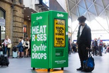 EDITORIAL USE ONLY Members of the public interact with prototype smart vending machine, as it is unveiled at London’s King’s Cross station by Sprite to bring to life their ‘Heat Happens’ campaign. Picture date: Wednesday July 12, 2023. PA Photo. The ‘smart vending machine’ uses live data to react to annoying moments of everyday commuter ‘heat’ - whether that’s ticket barrier bottlenecks, other people getting into your personal space or a train leaving 1 minute early - as the heat goes up, Sprite drops.