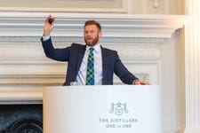 Jonny Fowle, Sotheby's Global Head of Spirits, fielding bids during The Distillers One of One auction, Hopetoun House, Scotland