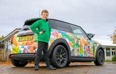 EDITORIAL USE ONLY Competition winner, Oliver Gorrod, aged 9 from Didcot looks on as a MINI Electric featuring his 'MINI Minds… with Crayola’ winning design is unveiled at his school, Sutton Courtenay C of E Primary School in Abingdon, Oxfordshire. Issue date: Monday November 13, 2023. PA Photo. The competition invited children aged 4-10 years old to predict the car of tomorrow, recognising that they are the generation who will grow up in a future dominated by electric cars.