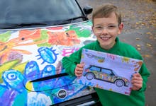 EDITORIAL USE ONLY Competition winner, Oliver Gorrod, aged 9 from Didcot looks on as a MINI Electric featuring his 'MINI Minds… with Crayola’ winning design is unveiled at his school, Sutton Courtenay C of E Primary School in Abingdon, Oxfordshire. Issue date: Monday November 13, 2023. PA Photo. The competition invited children aged 4-10 years old to predict the car of tomorrow, recognising that they are the generation who will grow up in a future dominated by electric cars