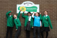 EDITORIAL USE ONLY Meadowside Primary school pupils (left to right) Junior, Theo, Esha, Lily, and Isabelle in front of a ‘Welcome to Weetabixshire’ sign which has been erected in the Northamptonshire town of Burton Latimer to mark the new proposed county lines of Weetabixshire. Picture date: Tuesday November 14, 2023. PA Photo. The breakfast cereal brand is petitioning to create a new county comprising a 50-mile radius from their Mills in Burton Latimer where all the wheat for the cereal is grown.