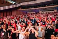 Audience members react to the announcement of Mary Kay’s expansion into Hungary. (Credit: Mary Kay Inc.)