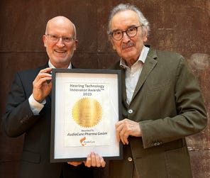 Dr. Reimar Schlingensiepen (left, CEO of AudioCure Pharma GmbH) and Prof. Hans Rommelspacher (founder and CSO) receive the award in the therapeutics category. (Photo: AudioCure Pharma)