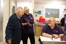 Holocaust survivor Steven Frank BEM with employees of the Watford Workshop