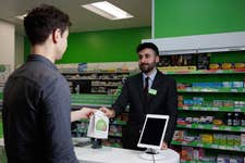 EDITORIAL USE ONLY Dave Hughes (left) is the first patient in England to be supplied medication under the Pharmacy First service, which launches today, by Superdrug Pharmacist Rahim Rahmani (right) in The Strand, London. Picture date: Wednesday January 31, 2024. PA Photo. Pharmacy First will be a service where pharmacists can provide people with professional health care advice, treatments, and medicines for seven common illnesses, instead of the patient going to a GP surgery.