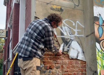 A crew from London’s Fine Art Restoration Company recovers Banksy’s Yellow Lines Flower Painter from a street in East London, following a request from the building owner. The restored wall is now on display at "Banksy - Restored Reclaimed" at Meuse Gallery, 601 E Hyman Avenue, CO 81611, through March 31st. (Photo: Business Wire)