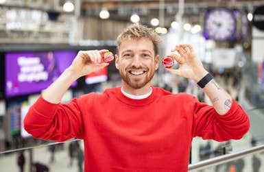 EDITORIAL USE ONLY Sam Thompson encourages commuters to ‘share a giggle’ at Waterloo station, London, ahead of this years Red Nose Day, as Babybel celebrates 25 years of sharing giggles with Comic Relief. Issue date: Monday February 26, 2024. A new study from Babybel found that sharing a giggle and doing a good deed are the things that make Brits feel best. The brand has raised over £1.75million for Comic Relief through its 25-year partnership with the charity.