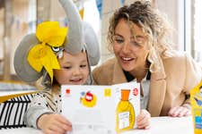 EDITORIAL USE ONLY Lydia Bright and her daughter Loretta, who is dressed as her favourite book character, visit McDonald’s in Chingford to read their free My Silly book, to celebrate World Book Day. Issue date: Monday March 4, 2024. PA Photo. A free copy of Mr Silly is available to collect in all restaurants on March 7, and a £1 book token is available on every Happy Meal box from now until March 26.