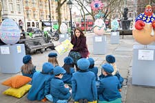 HRH Princess Eugenie reads to school children from Garden House School, at Elephant Family’s Little Egg Hunt, presented by Clarence Court, in Chelsea, London, an interactive large-scale egg hunt, with pieces designed by 12 leading designers. Picture date: Thursday March 21, 2024. PA Photo. Designers include Anya Hindmarch, Philip Colbert and Charlotte Colbert.