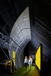 Visitors with a parabolic trough solar mirrors in Energy Revolution The Adani Green Energy Gallery at the Science Museum