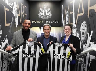 (Left to right) Senior Vice President at Sela, Ibrahim Mohtaseb, Chief Commercial Officer at Newcastle United Football Club (NUFC), Peter Silverstone and RNID Technology Lead, Dr Lauren Ward unveil Sela’s NUFC haptic shirts that will for the first time enable deaf fans to feel the atmosphere of the crowd inside St. James’ Park for Premier League game with Tottenham Hotspur on Saturday April 13. Sela will also donate its front-of-shirt logo placement and pitch side advertising rights to major deaf and hearing loss charity RNID for the game.