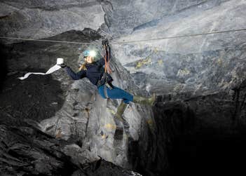 Isabella Betts abseils through an abandoned Victorian slate mine in Snowdonia, Wales as Domestos launch their new campaign to find adventurous members of the public to take part in The Longest Drop experience, in celebration of their newest product, Domestos Power Foam. Issue date: Thursday April 18, 2024. PA Photo. The Longest Drop follows on from 2023's Loo With A View experience and will see participants journey 1375ft underground to the nationÕs 'hardest-to-reach' toilet.