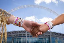 EDITORIAL USE ONLY Andreia and Alex display their bracelets outside Wembley Stadium, London as Uber releases limited edition bespoke, colour-coded friendship bracelets in Ubers across Edinburgh, Liverpool, Cardiff and London to celebrate Taylor Swift’s The Era’s tour coming to the UK. Issue date: Wednesday May 1, 2024. PA Photo. The colour-coded friendship bracelets will be available to Uber riders to share and swap at concerts during this summer of concerts, with 200 of the bracelets also including a special code that offers £20 off Uber Reserve trips