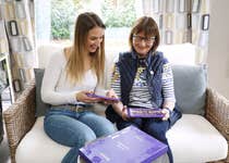 EDITORIAL USE ONLY Layla Andrews and her mum Karen at their home in Sussex following requests from people caring for those living with dementia for nostalgic packaging to support reminiscence activities, Cadbury has partnered with Alzheimer’s Research UK to release ‘Memory Bar Boxes’. Issue date: Tuesday May 14, 2024. PA Photo. The boxes aim to stimulate conversation and support memory activities for people living with dementia and their loved ones. 3,000 boxes will be distributed to care homes and Alzheimer’s Research UK supporters throughout Dementia Action Week this week, with 1,000 available for those caring for loved ones at home.