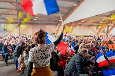 A supporter of the French far-right Rassemblement National (RN) is waving a national flag. The European Union is facing growing voter support for far right parties ahead of the upcoming elections for the European Parliament. (Photo by Jean-Christophe Verhaegen/AFP)