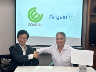 Yiyun Chang, Vice President at Compal Electronics, Inc. (left), shaking hands with Dr. Ali Sadri, CTO of Airgain, Inc., after signing a strategic MOU. (Photo: Business Wire)