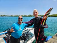 Celia Kent (80) & coach Brett Hodgkins after she slalom waterskied at Chichester Water Ski Club to celebrate her milestone birthday. Picture date: 15 June 2024. Photo credit: British Water Ski & Wakeboard