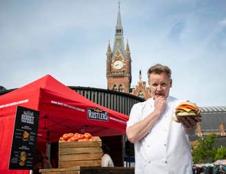 Gordon Ramsay lookalike Martin Jordan cooks Rustlers burgers at a pop-up for the brand at King’s Cross Station in London, to create a buzz around their "Boost Your Burger" campaign. Picture date: Tuesday June 18, 2024. PA Photo. The lookalike and campaign have been implemented in order to challenge perceptions of Rustlers. The burgers are 100% British and Irish beef, and can be ‘elevated’ with toppings such as lettuce and tomato.