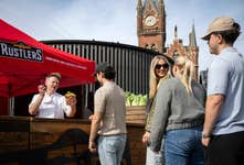 Gordon Ramsay lookalike Martin Jordan cooks Rustlers burgers at a pop-up for the brand at King’s Cross Station in London, to create a buzz around their "Boost Your Burger" campaign. Picture date: Tuesday June 18, 2024. PA Photo. The lookalike and campaign have been implemented in order to challenge perceptions of Rustlers. The burgers are 100% British and Irish beef, and can be ‘elevated’ with toppings such as lettuce and tomato.