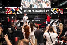 Aitch and Shaun Williamson perform Sweet Caroline on the Coca-Cola Zero Sugar stage at BOXPARK in Wembley ahead of England’s UEFA EURO 2024 game against Denmark. Picture date: Thursday June 20, 2024. PA Photo. New research from Coca-Cola Zero Sugar revealed that Sweet Caroline ranked the nation's favourite football anthem, above Three Lions and We Are The Champions.