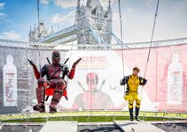 EDITORIAL USE ONLY(Left to right) Superfans Steve Parker and Steve Paulson dressed as Deadpool and Wolverine, ‘get wet and get wild’ on the waterfall swing, unveiled by Actiph Water at London's Potters Fields Park today, in celebration of their partnership with Marvel Studios’ Deadpool & Wolverine. Picture date: Wednesday July 17, 2024.