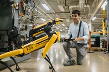 Pictures shows Rover the Boston Dynamics robot dog in JaguarLandrover Coventry facility. Pictured with specialist handler Gonzalo.