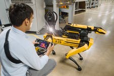 Pictures shows Rover the Boston Dynamics robot dog in JaguarLandrover Coventry facility. Pictured with specialist handler Gonzalo.