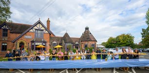 A group of pub goers hold up a 12.12m long bratwurst created by Seared Pubs in Droitwich Spa to celebrate the launch of its Oktoberfest menu. Issue date: Sunday September 22, 2024. PA Photo. Complete with crispy onions and curry ketchup, the bratwurst represents the 1,212km between the pub and Theresienwiese, Munich, the home of Oktoberfest.