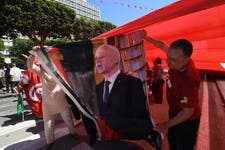 Backing for the President: Supporters of Tunisian President Kais Saied hold his image during a rally in Tunis, on July 25, 2024, as the nation celebrates the 67th anniversary of foundation of the republic.