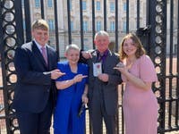 Will with his grandparents and sister collecting Dad Rob's OBE