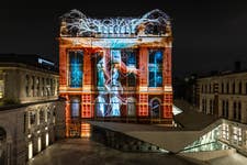 EDITORIAL USE ONLYA preview of a specially commissioned AI artwork from Ouchhh Studio, made using cognitive technology to visualise brainwaves of the Arts & Film ‘Game Changers’ is projected across the façade of the V&A’s Exhibition Road Courtyard building in London, ahead of it being publicly unveiled tomorrow night as part of The National Lottery’s 30th birthday celebrations. Picture date: Thursday October 31, 2024. PA Photo. Thanks to National Lottery players, more than £30 million is raised every week for good causes, and this is the final of four unique activities taking place across the UK in the build-up to celebrating The National Lottery’s 30th Birthday on November 19.