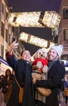 EDITORIAL USE ONLY L-R - Alex Lively and Jonny Gemma with Rafi the Cockapoo at the the new Christmas Lights, titled ‘Into The Light’ are switched-on at London’s Carnaby Street. Picture date: Thursday November 7, 2024. PA Photo. The new six-metre sculptural light display, features thousands of energy-efficient LEDs and will be in-situ for a five-year period