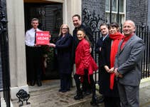 EDITORIAL USE ONLY Campaigners Dr Charmaine Griffiths, David Seaman, Frankie Seaman, Hugh Matthews, Tara Deboys and James Wilkinson deliver a pledge with close to 50,000 signatures to No. 10 Downing Street, part of the charity’s Hearts Need More campaign, urging the UK Government to make tackling cardiovascular disease a priority. Picture Date: Wednesday December 4, 2024. PA Photo. Joining campaigners, including Labour MP Danny Beales and BHF ambassadors David and Frankie Seaman, is James Wilkinson, who was diagnosed with a heart infection in late 2019. After repeated operation cancellations, he sought private heart valve repair. Latest NHS England figures show over 172,000 people on the heart care waiting list waited longer than the 18-week treatment target.