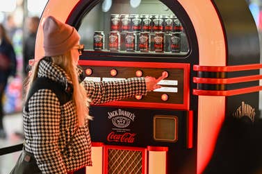 EDITORIAL USE ONLY EMBARGOED TO 0001 MONDAY DECEMBER 16Members of the public pick alternative festive songs using the Jack Daniel’s & Coca-Cola Jukebox, designed to reinvent the Christmas soundtrack, at London’s Battersea Power Station. Issue Date: Monday December 16, 2024. PA Photo. Visitors are invited to select their favourite track and receive a complimentary sample of Jack Daniel’s & Coca-Cola.