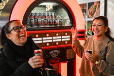 EDITORIAL USE ONLY EMBARGOED TO 0001 MONDAY DECEMBER 16Members of the public pick alternative festive songs using the Jack Daniel’s & Coca-Cola Jukebox, designed to reinvent the Christmas soundtrack, at London’s Battersea Power Station. Issue Date: Monday December 16, 2024. PA Photo. Visitors are invited to select their favourite track and receive a complimentary sample of Jack Daniel’s & Coca-Cola.