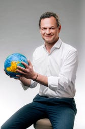 Thierry Navarre, CEO of Cedo, pictured with a globe made from some of the 200,000 tons of recycled soft plastics that Cedo is now capable of processing each year. (Photo: Business Wire)