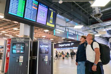 Family checking departure board