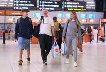 A family walking through London Luton Airport