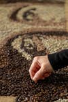 EDITORIAL USE ONLY Michelle Wibowo creates a portrait of Harry Kane out of coffee beans for Starbucks x Harry Kane Foundation, West Sussex. Picture date: Tuesday March 4,Photo credit should read: Jas Lehal/PA Media Assignments 2025.