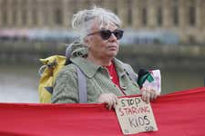 EDITORIAL USE ONLY People take part in a pro-Palestine protest on Westminster Bridge in London, as over ten thousand people form a red line around the Houses of Parliament calling for Prime Minister Sir Keir Starmer to sanction Israel after it continues its military offensive and aid blockade in Gaza. The banner reads: Starmer! Starving Children is a Red Line. Arms Embargo now. Picture date: Wednesday June 4, 2025. PA Photo.