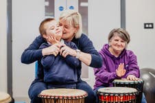 Max and his mum Lisa enjoying playing the drums, along with (right) Joyce Rainey, Developing MSI Consultant at Sense