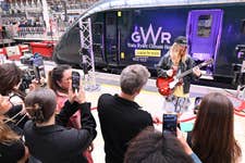 EDITORIAL USE ONLY Sam Ryder performs an impromptu gig at London Paddington Station at the unveiling of his newly branded ‘Train Ryder’ Great Western Railway train, which is part of the ‘I came by train’ campaign, supported by Trainline to encourage sustainable travel to Glastonbury Festival and beyond. Picture date: Monday June 23, 2025. PA Photo. The one-off special train will be in service over the summer, as part of a major sustainability initiative, aimed at shifting behaviours around travel. With transport making up the biggest slice of the average UK citizen's carbon footprint, choosing the train is a simple but powerful climate action change.