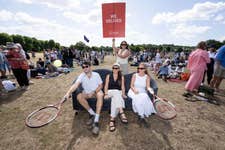 EDITORIAL USE ONLY: Joseph Cousins from London, Laura Hill from London, Amelia Komor from Surrey and Emily McCormick from London sit on a preloved sofa delivered by the British Heart Foundation to the Wimbledon queue, giving those waiting in line a chance to rest their legs and take a break. Picture date: Tuesday July 8, 2025. PA Photo. The sofa, sourced from the local Kingston British Heart Foundation store, showcases the charity’s wide range of second-hand furniture and highlights its nationwide delivery service.