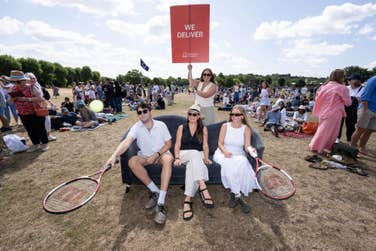 EDITORIAL USE ONLY: Joseph Cousins from London, Laura Hill from London, Amelia Komor from Surrey and Emily McCormick from London sit on a preloved sofa delivered by the British Heart Foundation to the Wimbledon queue, giving those waiting in line a chance to rest their legs and take a break. Picture date: Tuesday July 8, 2025. PA Photo. The sofa, sourced from the local Kingston British Heart Foundation store, showcases the charity’s wide range of second-hand furniture and highlights its nationwide delivery service.