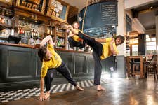 EDITORIAL USE ONLY (Left to right) Sara Pourcher, Ashley Smith and Jo Hayes from Capoeira Communities, one of the grassroots sports clubs supported by Greene King IPA’s Proud to Pitch In scheme, perform at the Greene King Wig and Pen pub in Oxford. Issue date: Wednesday July 16, 2025. PA Photo. Since its launch in 2021, more than 370 teams have been supported by the Greene King IPA scheme, which gives clubs the opportunity to apply for funding for kit, equipment and venue hire, with £1 million in funding having been given to clubs across the UK. Research reveals one in four grassroots sports clubs is at risk of closure due to financial pressure.