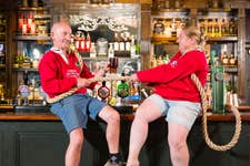 EDITORIAL USE ONLY (Left to right) Denis Green and Georgie Read from Felton Eccles Tug of War, one of the grassroots sports clubs supported by Greene King IPA’s Proud To Pitch In scheme, hold a rope on the bar at the Greene King Wig and Pen pub in Oxford. Issue date: Wednesday July 16, 2025. PA Photo. Since its launch in 2021, more than 370 teams have been supported by the Greene King IPA scheme, which gives clubs the opportunity to apply for funding for kit, equipment and venue hire, with £1 million in funding having been given to clubs across the UK. Research reveals one in four grassroots sports clubs is at risk of closure due to financial pressure.