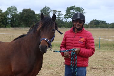 Brooke staff with horse at Redwings Horse Sanctuary in Norfolk.