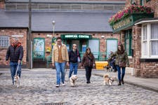 EDITORIAL USE ONLYDog walkers on the Coronation Street cobbles in Manchester during the one-of-a-kind 'Canineration Street' tour of the programme's set. The tour marks the first time guests are able to bring their dogs onto the Weatherfield cobbles, with around 200 dog fans and their owners from across the UK present, and proceeds from dog tickets donated to Dogs Trust. Picture date: Sunday April 12, 2026. PA Photo.