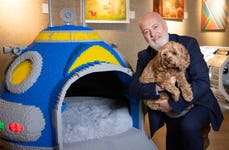 EMBARGOED TO 0001 FRIDAY MAY 8 EDITORIAL USE ONLY Bill Bailey with Toto the Yorkshire Cavapoo at the Barkitecture preview evening, showcasing kennel concepts inspired by this year’s brief ‘Dogs in Space’, which will be auctioned by Bonhams at Goodwoof, taking place at the Goodwood Estate in West Sussex next weekend, May 16 and 17. Issue date: Friday May 8, 2026. PA Photo. Sixteen architects and designers from around the world are taking part in the competition, with all monies raised donated to the event’s charity partner, Battersea.